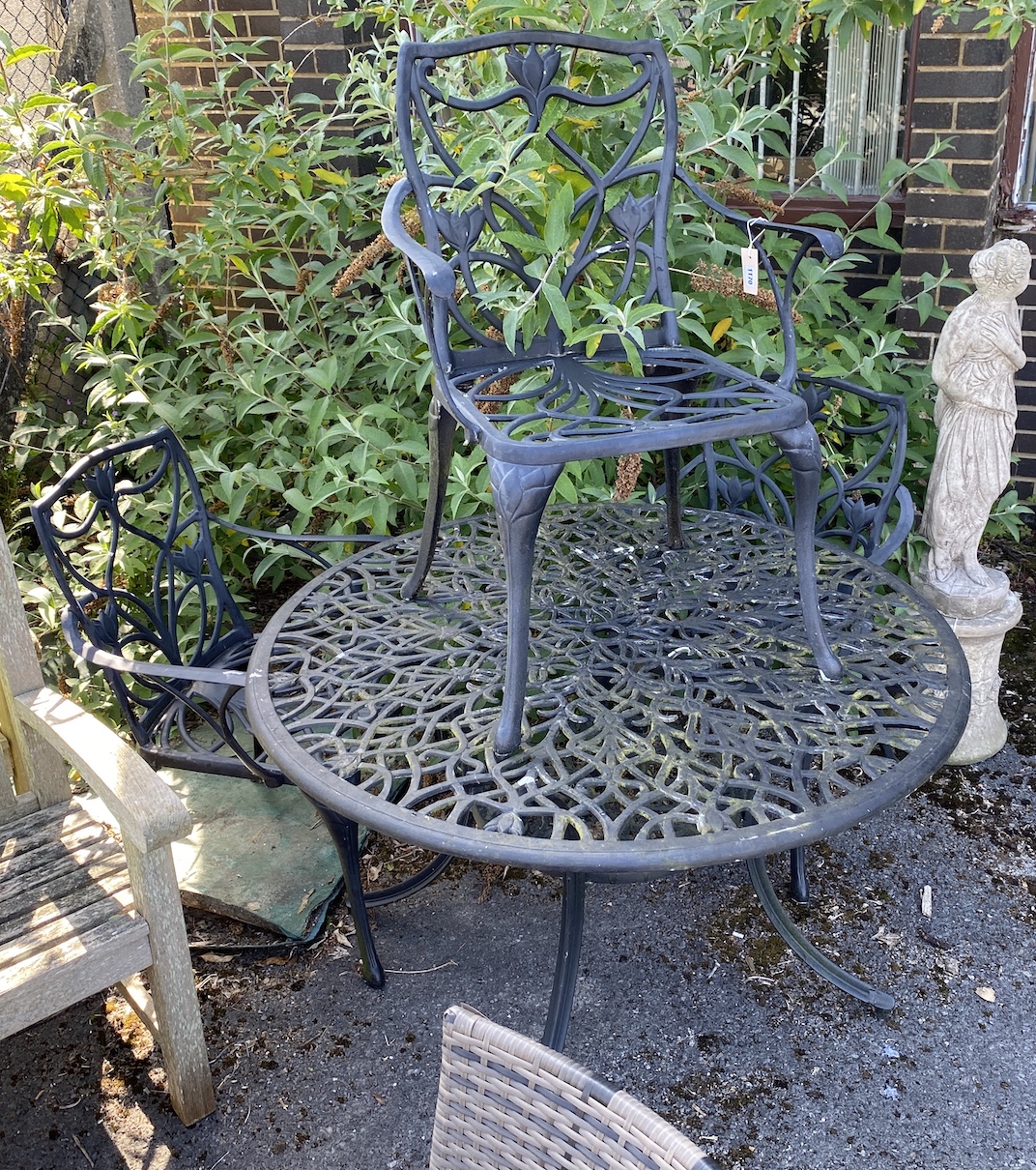 A circular painted aluminium garden table and three chairs, table 120cm diameter, height 72cm